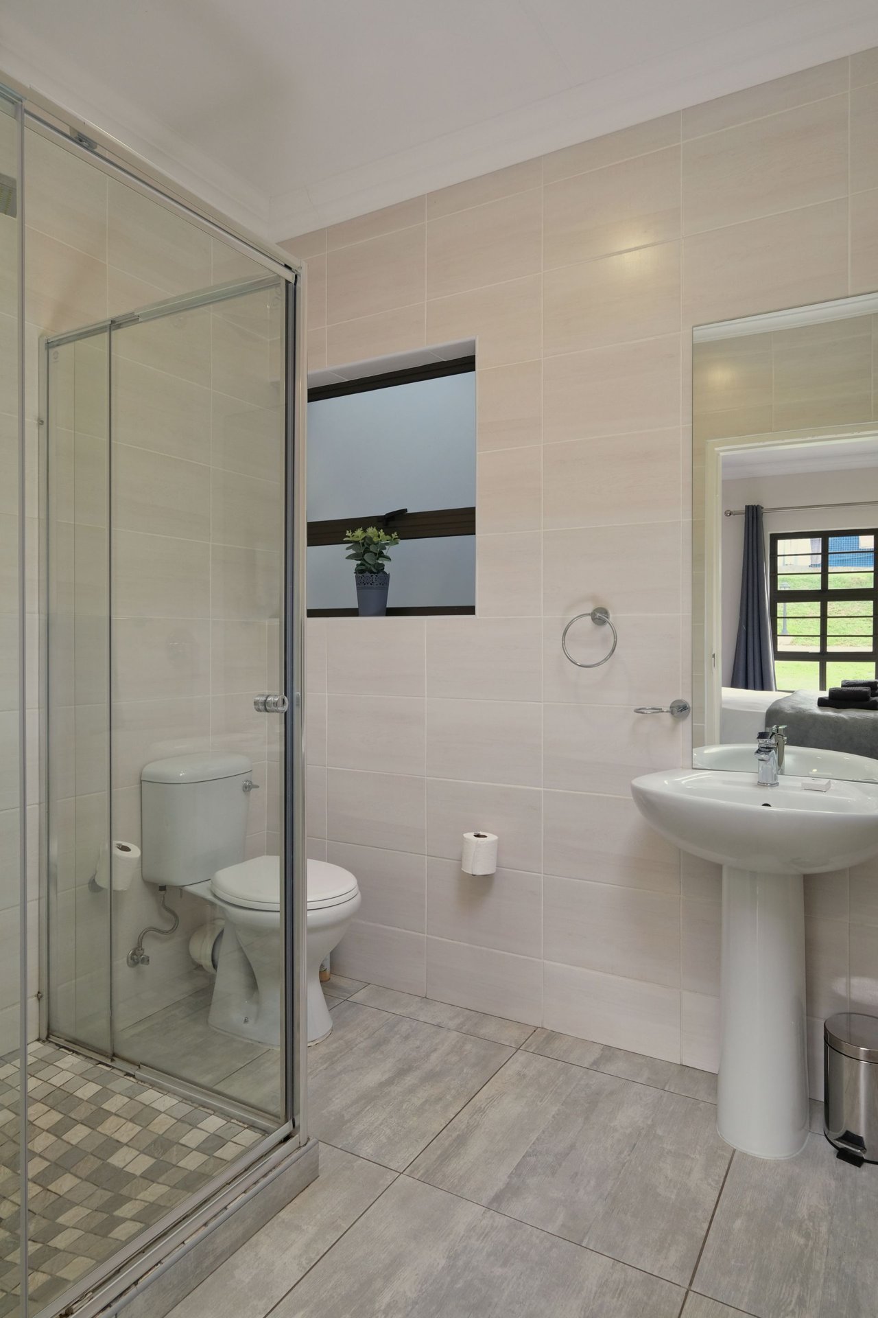 Finished bathroom with a glass shower and tiled floor — illustrative image