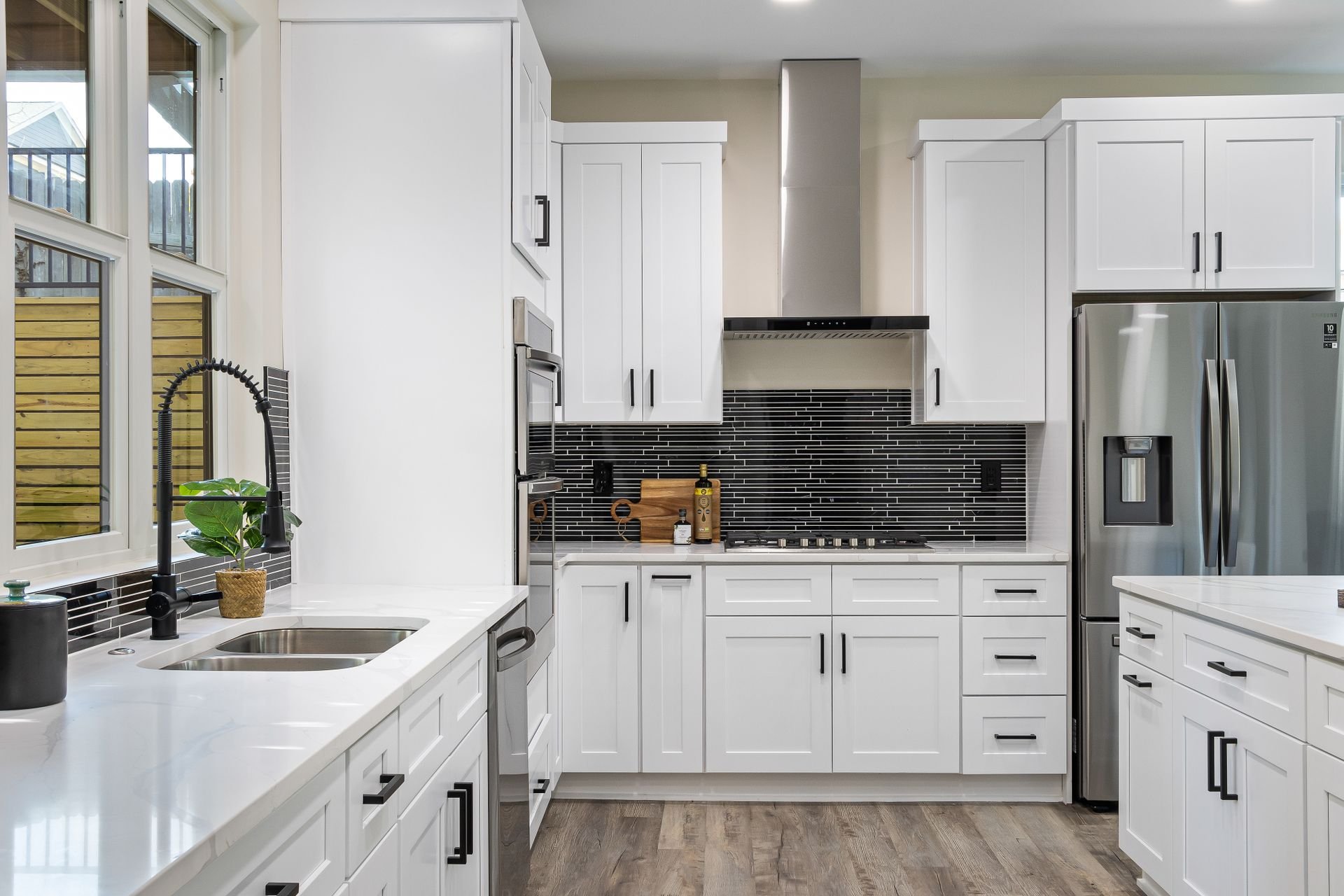 Finished residential kitchen with white cabinets and a tile backsplash — illustrative image